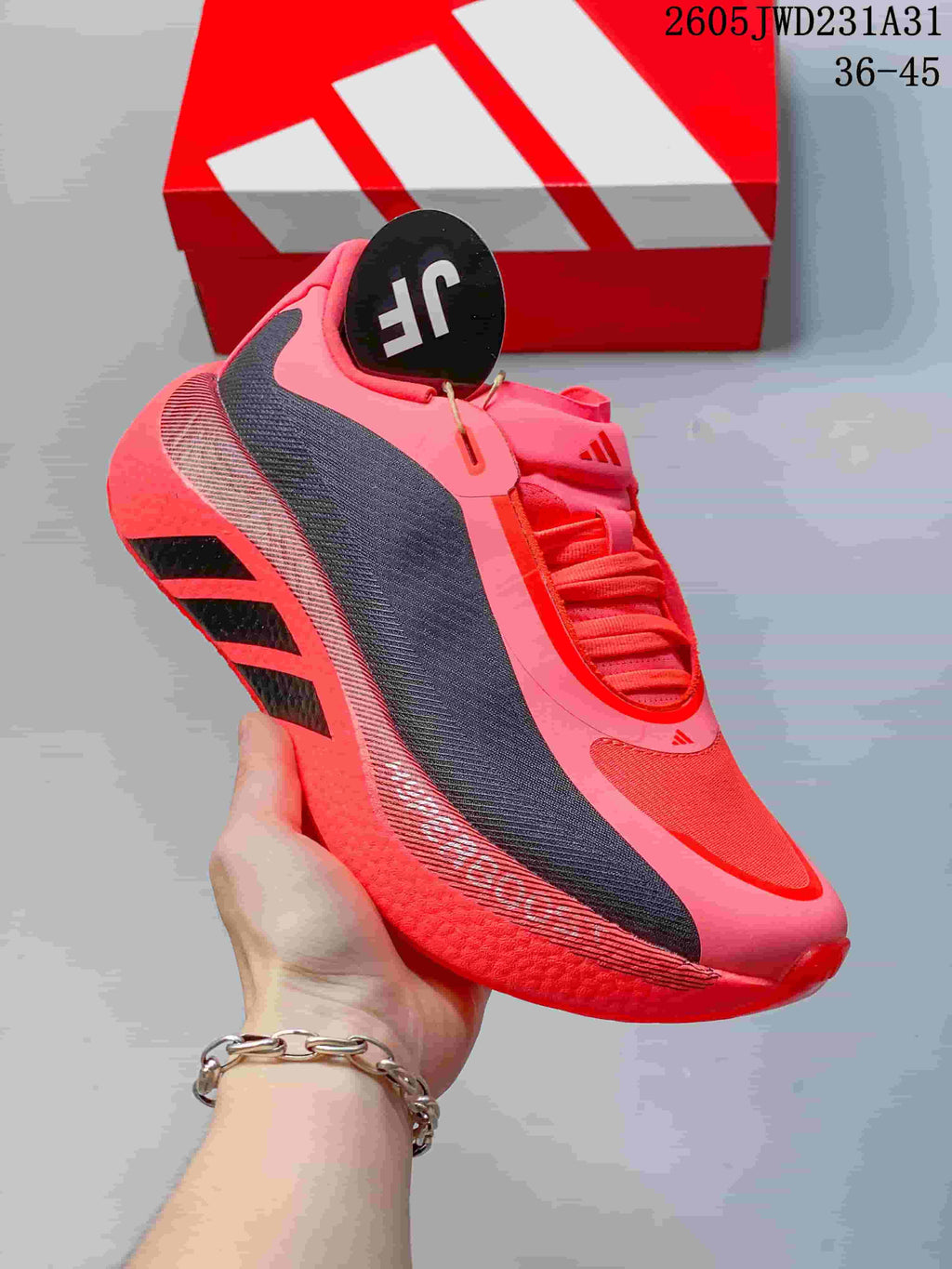 Angled side view of the bright pink shoe showing its dark panels and sculpted outsole.