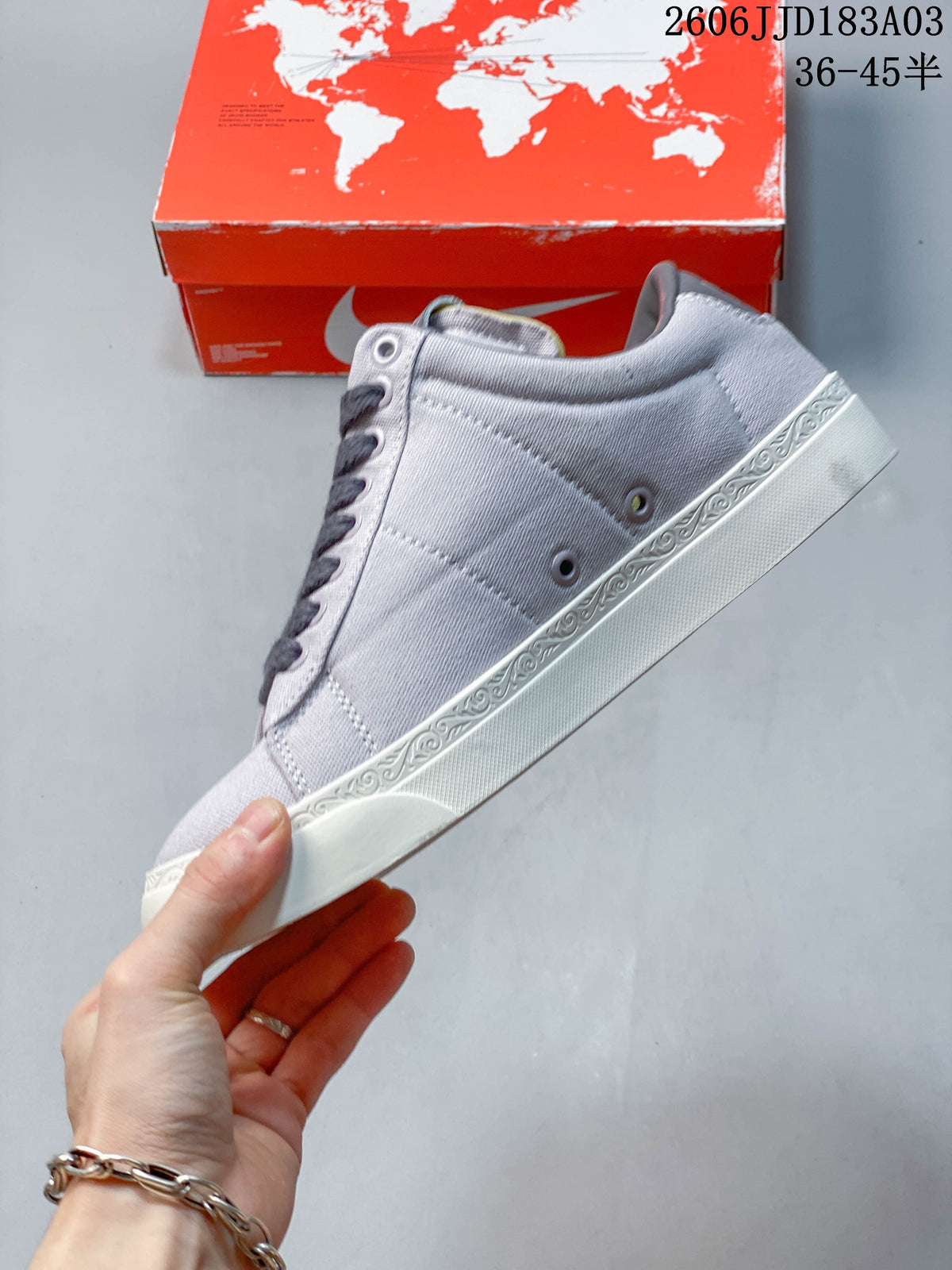 Side view of a light gray Nike Devin Booker Blazer sneaker with decorative white sole trim