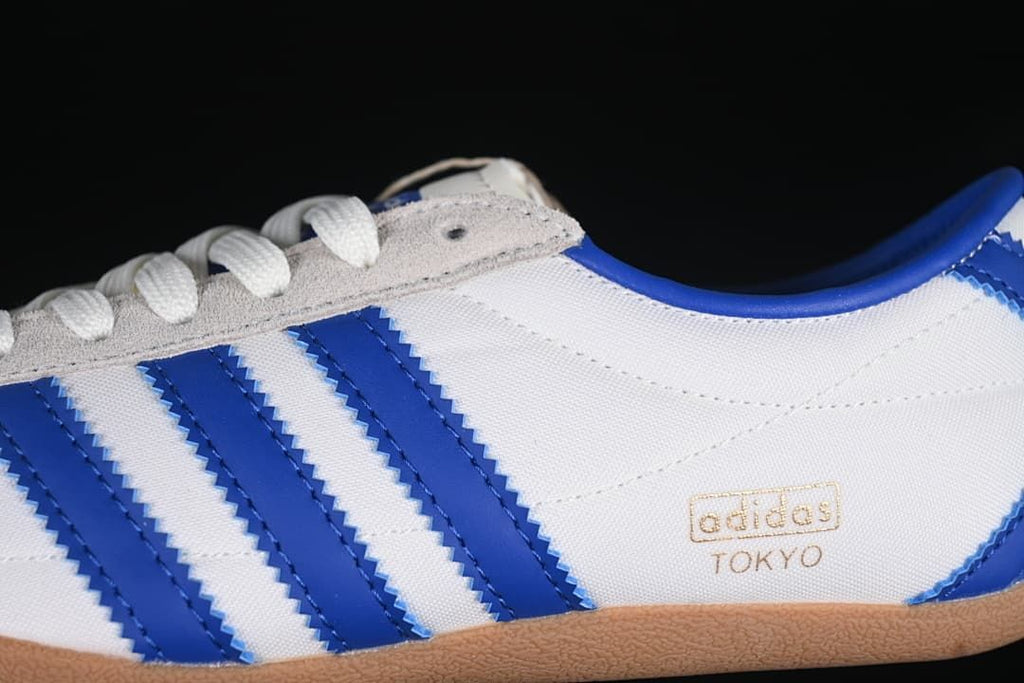Close-up of blue side stripes, grey eyelet panel and Tokyo branding
