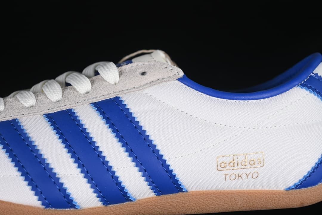 Close-up of blue side stripes, grey eyelet panel and Tokyo branding