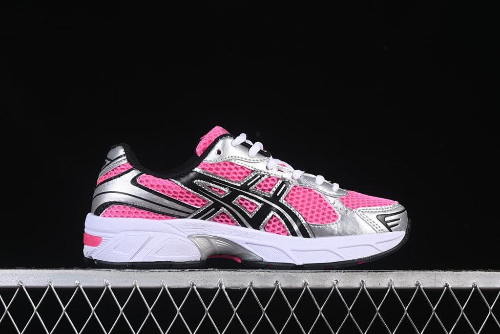 Side profile of a pink and silver sneaker with black accents.