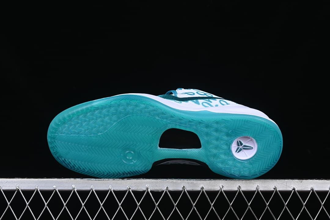 Underside view of the teal outsole and central cutout