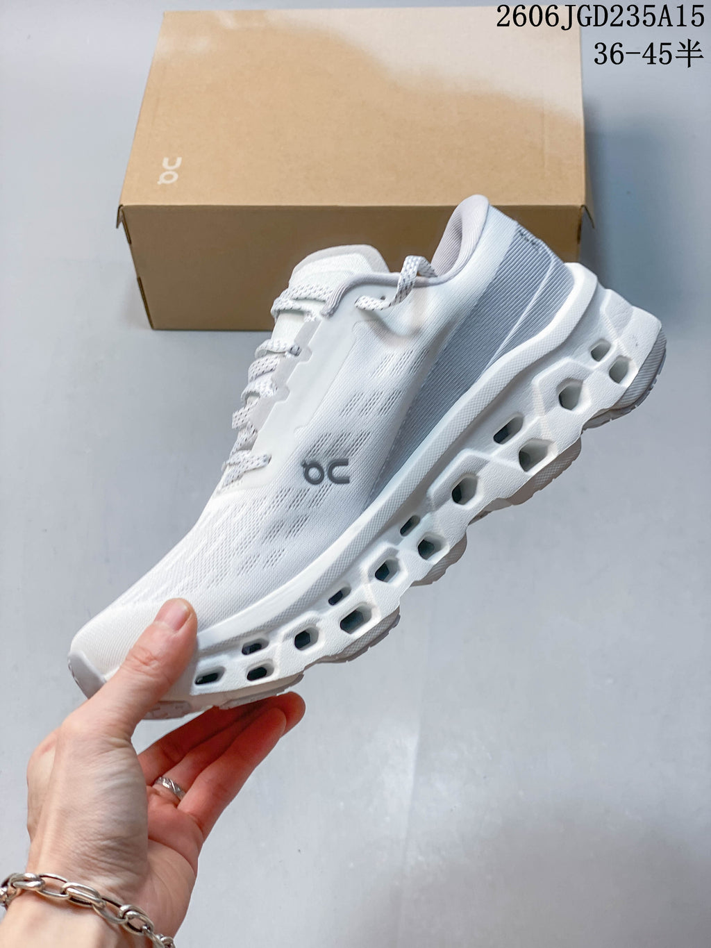 Side profile of a white On Cloudmonster 3 sneaker showing its segmented sole