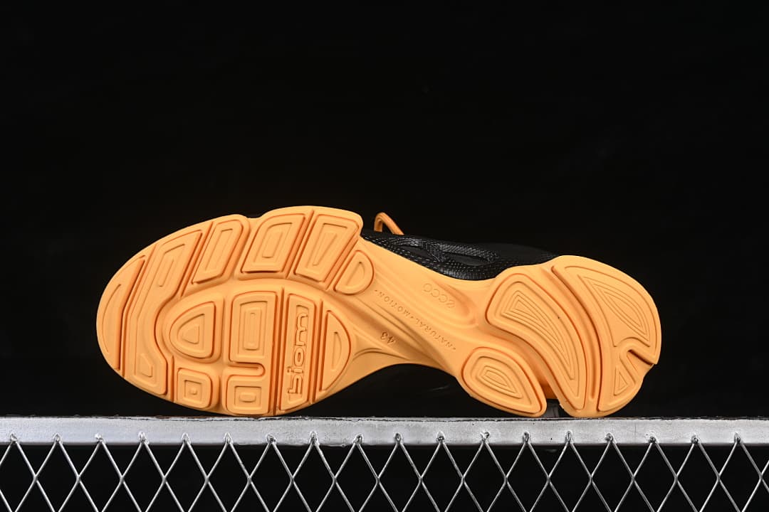 Underside view showing the orange patterned outsoles