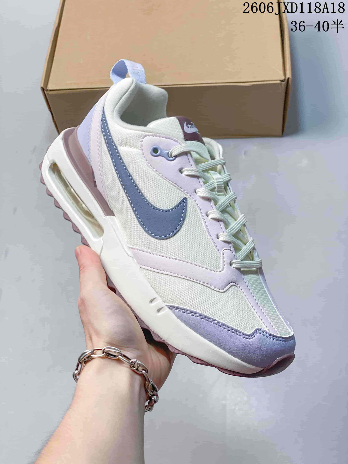 White Nike Air Max Dawn sneaker with lavender and blue accents