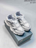 Pair of gray and white New Balance W603 sneakers shown from above on a shoebox