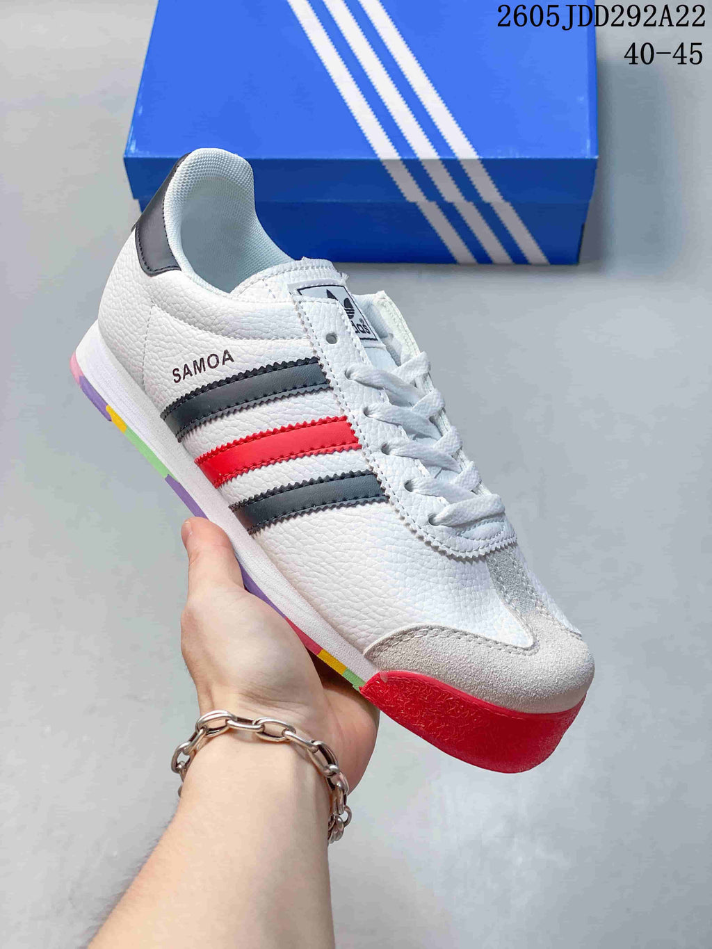 Angled side view highlighting the Samoa name, gray and red stripes, and multicolor outsole.