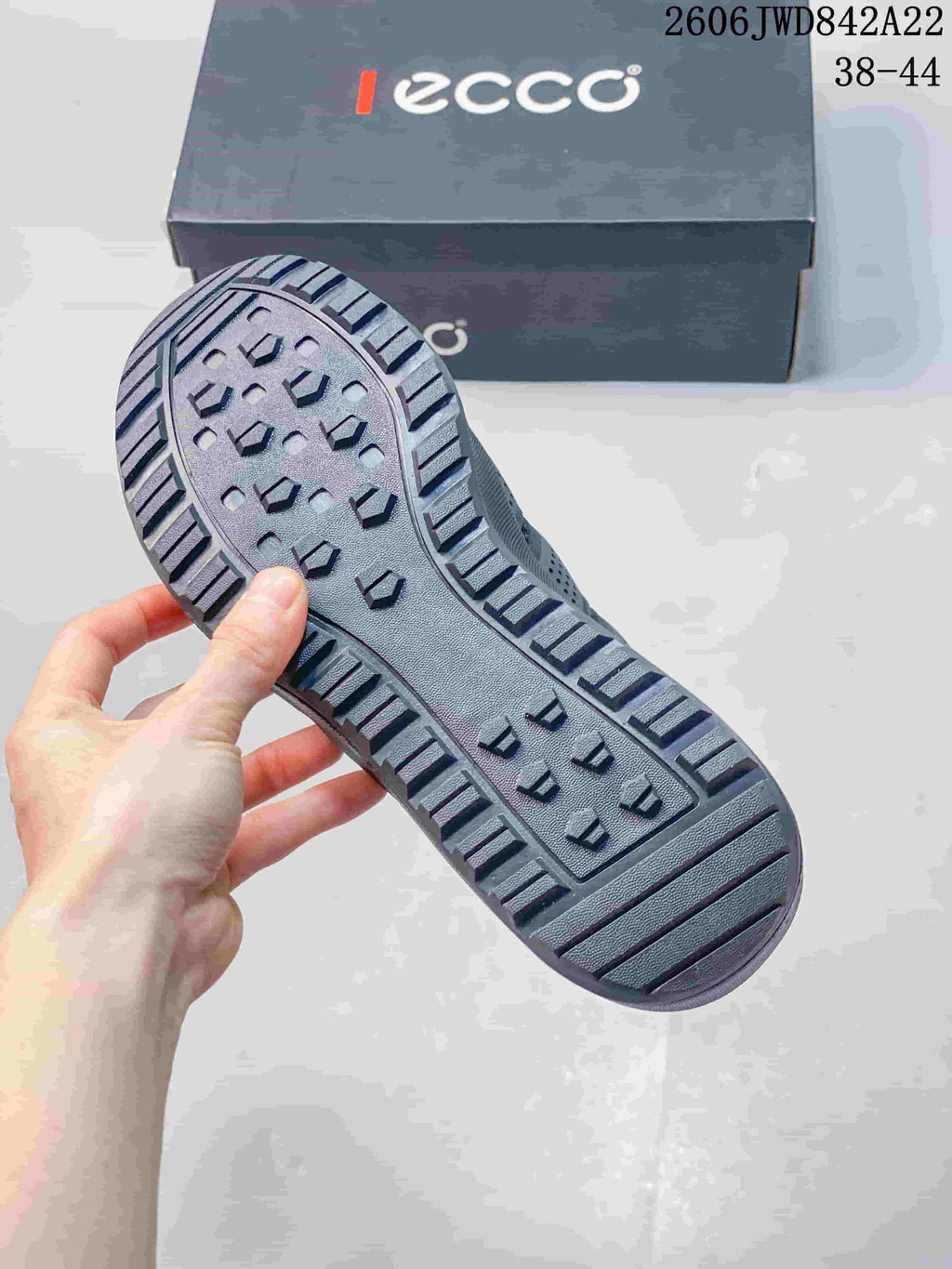 Close-up of the lugged outsole on a gray sneaker