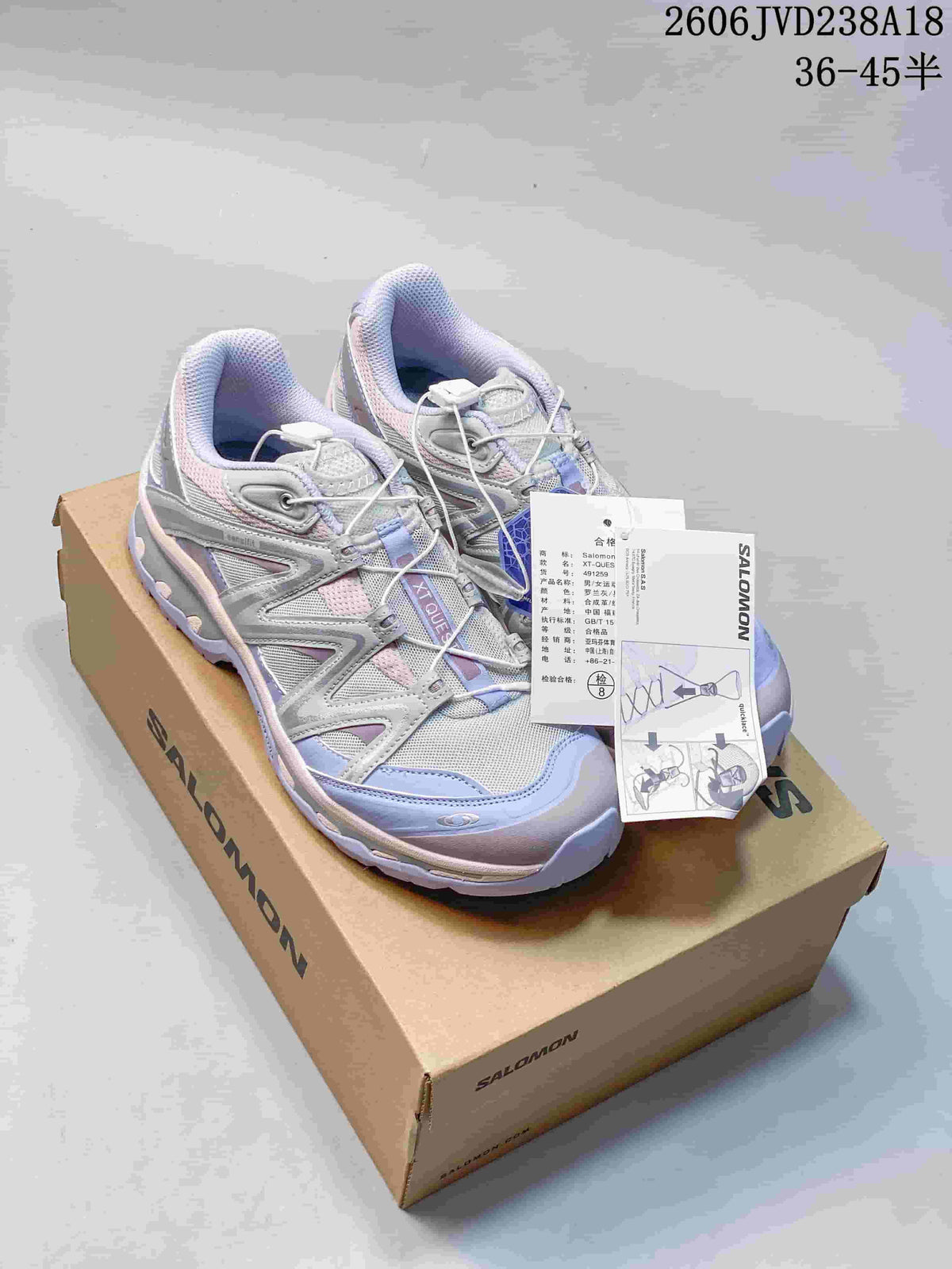 Salomon XT-Quest ATHR sneakers on a shoebox, showing the silver, lavender and pale pink colorway.