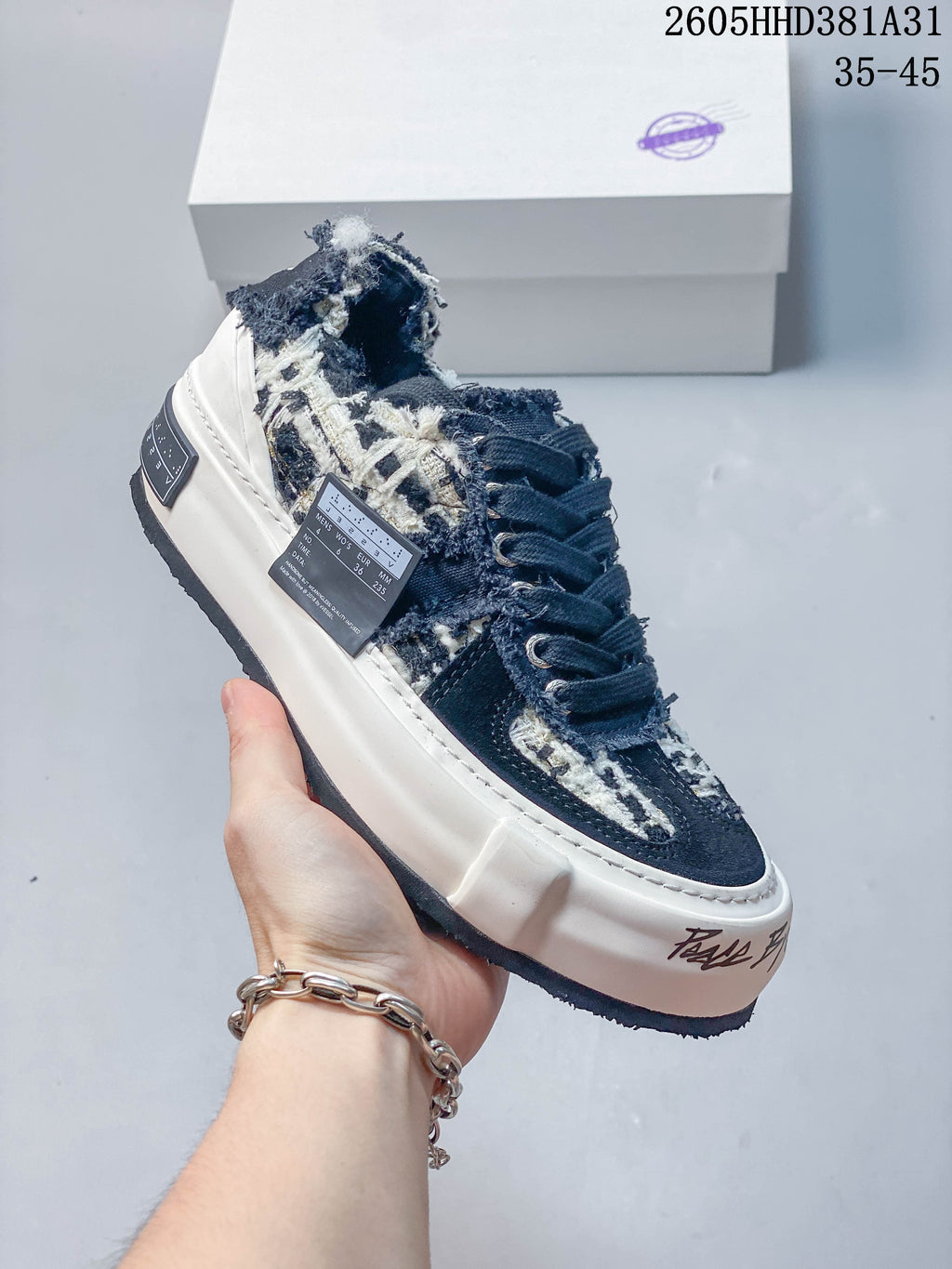 Side view of a navy patterned xVESSEL G.O.P. Low sneaker; size label is visible