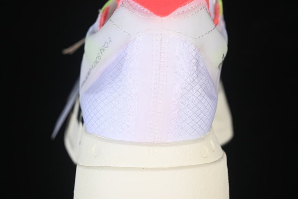Rear view of the shoe showing its patterned heel and coral-colored collar.