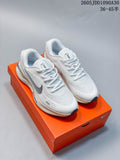 Pair of white Nike Journey Run running shoes with gray accents shown on an orange shoe box.