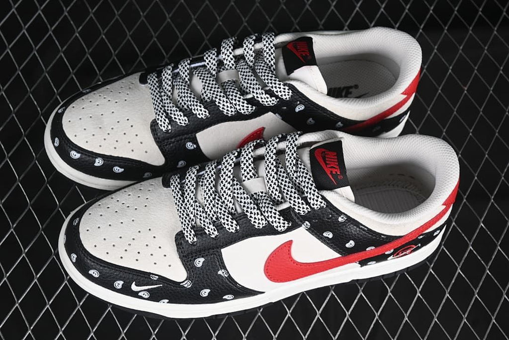 Pair of black, white, and red low-top sneakers shown from above.