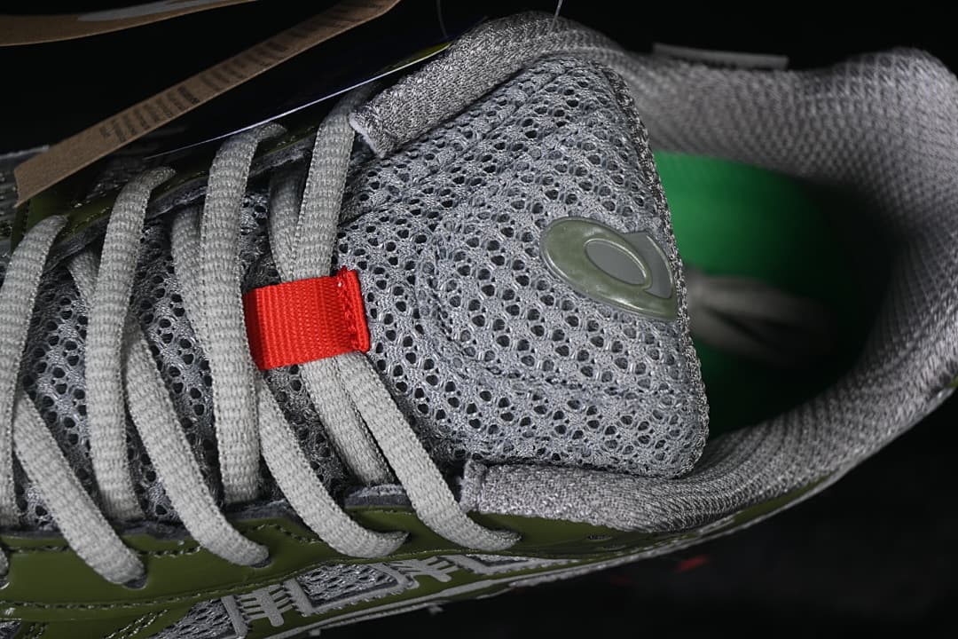Close-up of the gray tongue, laces, and coral lace detail.