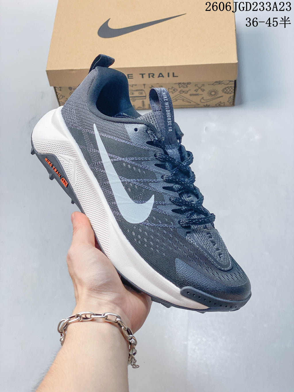 Angled side view of the gray Nike Wildhorse 10 trail shoe with white Swoosh