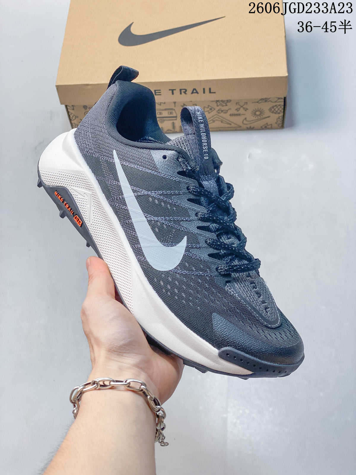 Angled side view of the gray Nike Wildhorse 10 trail shoe with white Swoosh
