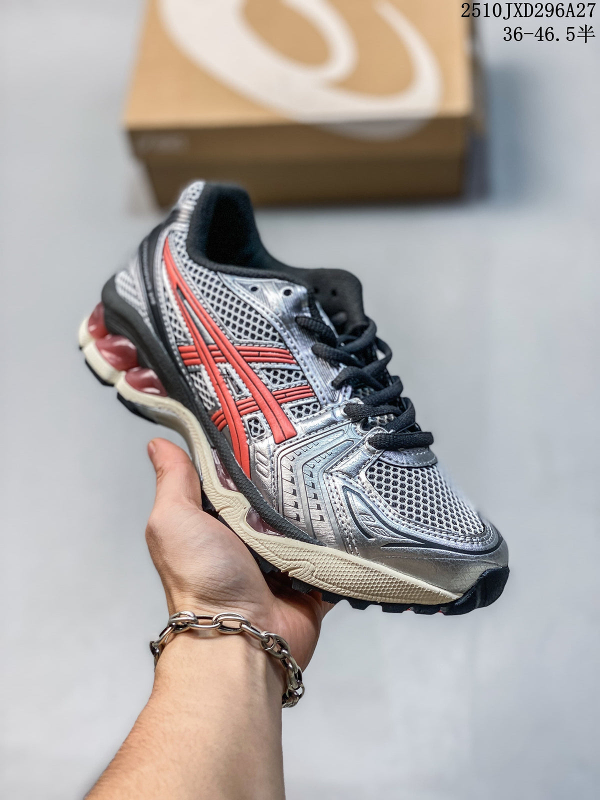 Silver and black mesh sneaker with coral-red accents and a cream-colored sole, held in hand.