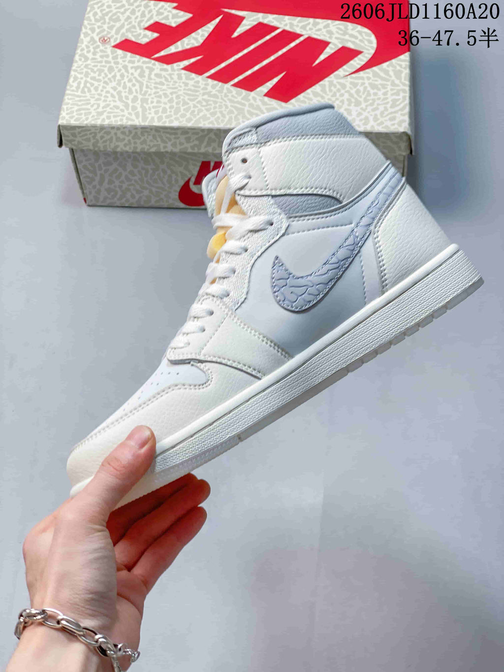 Side view showing the grey patterned Swoosh and high-top profile