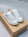 White textured low-top sneakers with pale pink heel panels and a thick white sole; size range 35–40 appears in the image.
