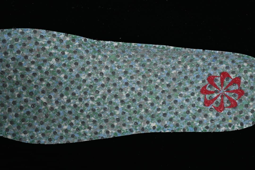Reverse side of the patterned insole with a red emblem