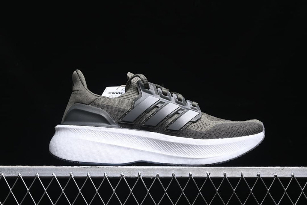 Side profile of the shoe showing the olive upper, three stripes, and white midsole