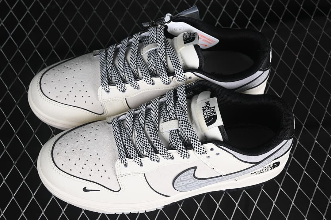 Pair of off-white and grey low-top sneakers with patterned laces