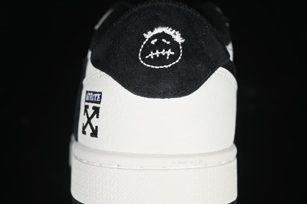 Rear view showing contrasting heel panels and embroidered details.