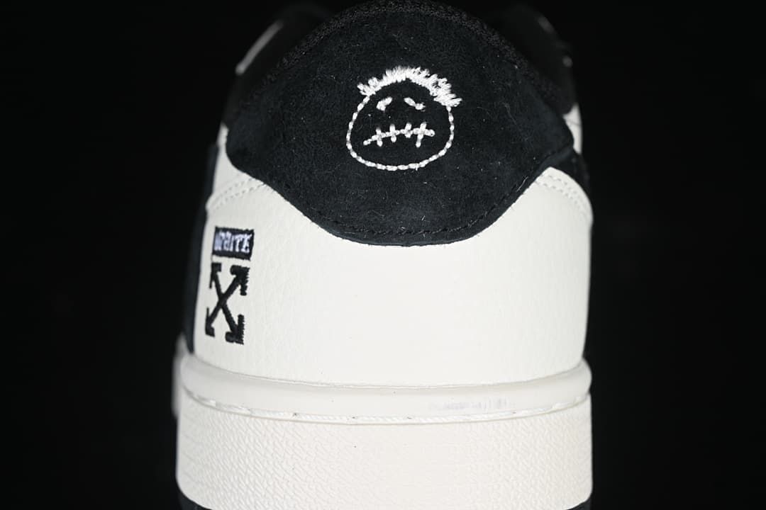 Rear view showing contrasting heel panels and embroidered details.
