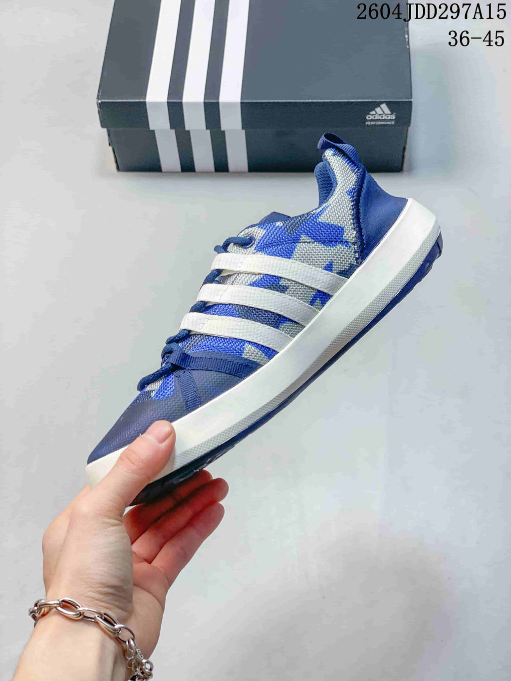 Side profile of a blue and gray adidas Terrex CC Boat shoe