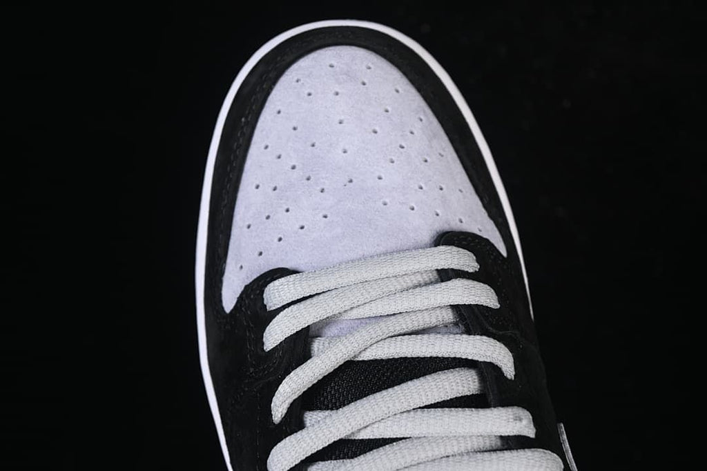 Overhead view of the perforated grey toe panel and light-coloured laces