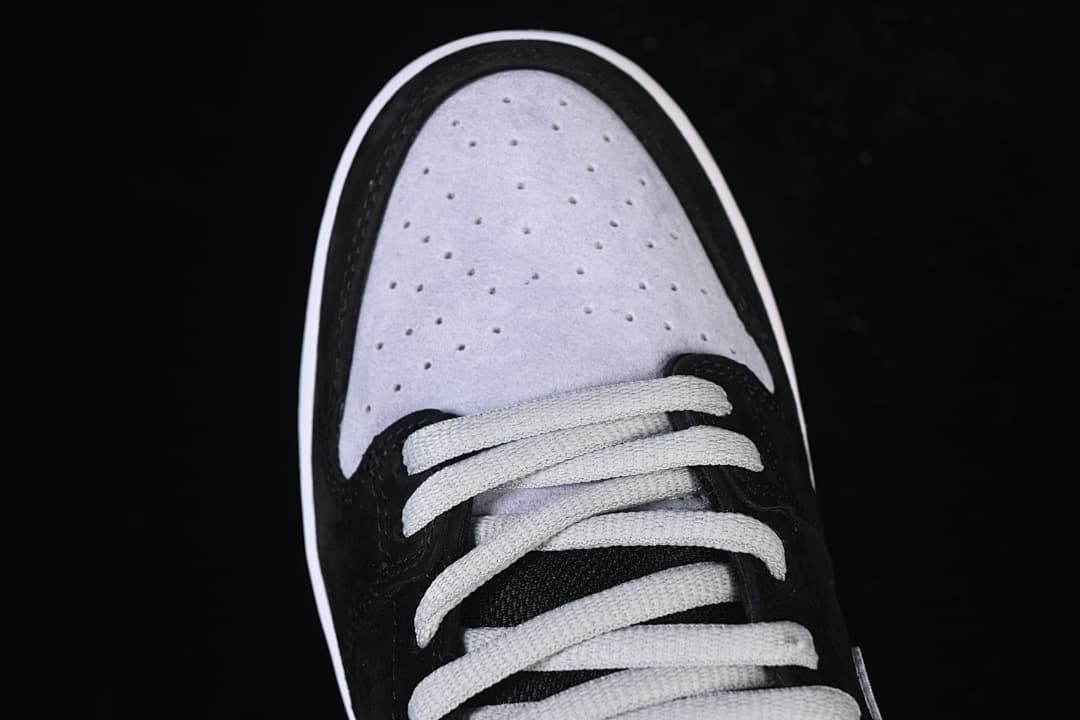 Overhead view of the perforated grey toe panel and light-coloured laces