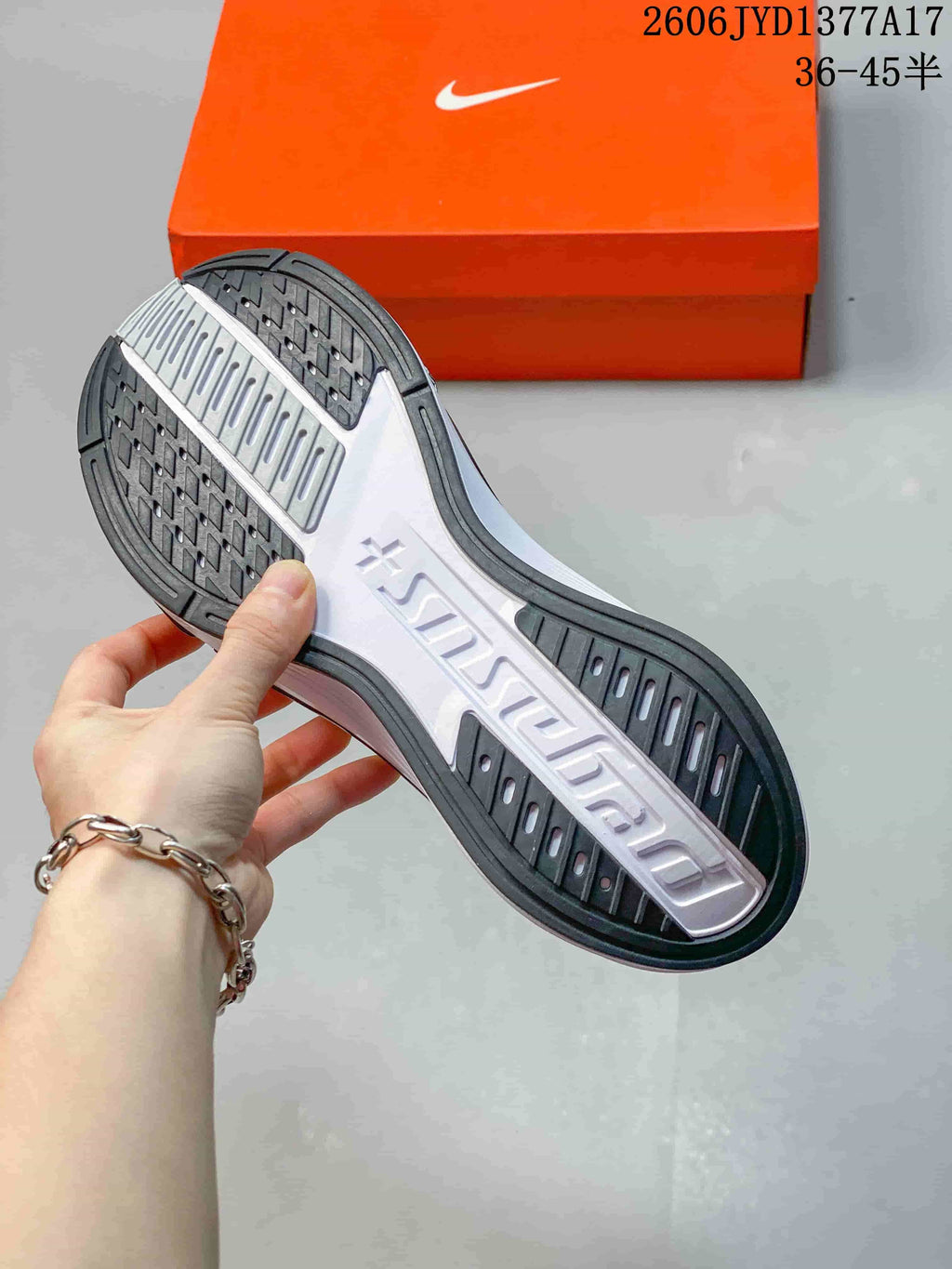 Outsole of a Nike Zoom Plus sneaker showing dark tread and a white center section