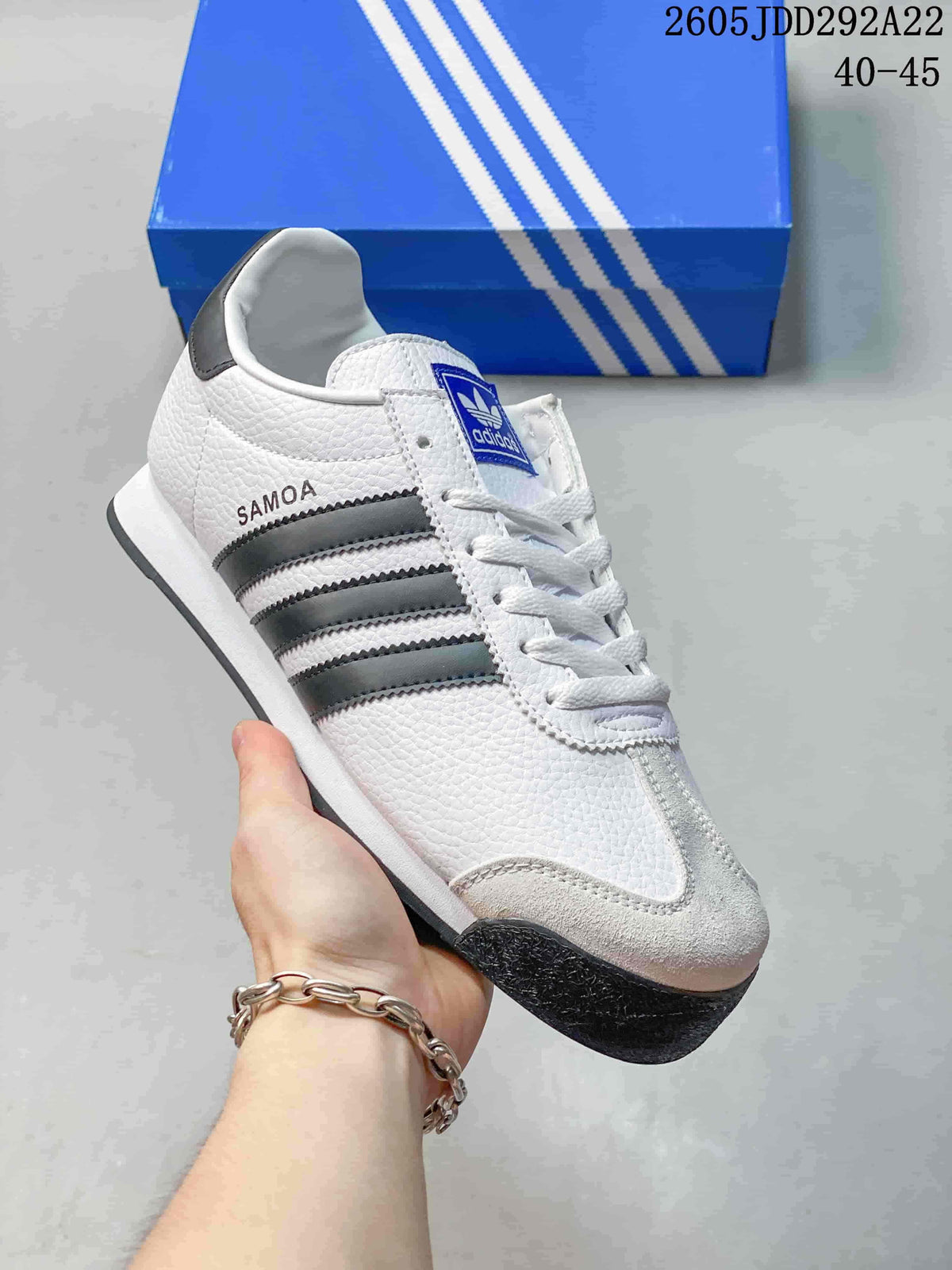 White Adidas Samoa low-top sneaker with dark gray stripes