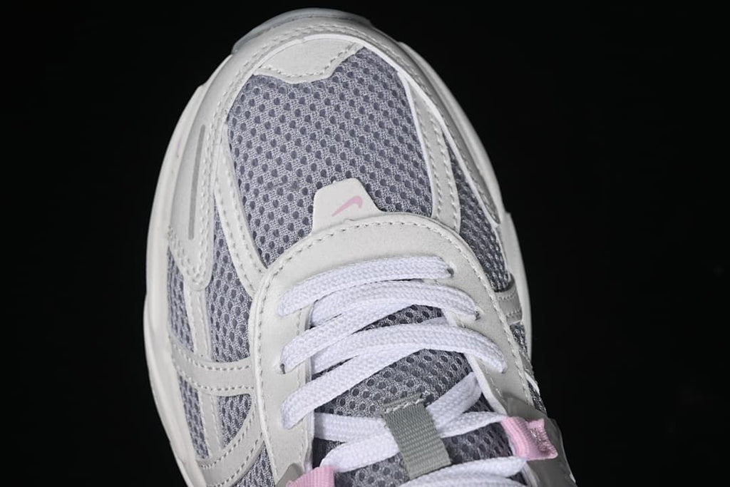 Top-down close-up of the sneaker toe, mesh, and laces.