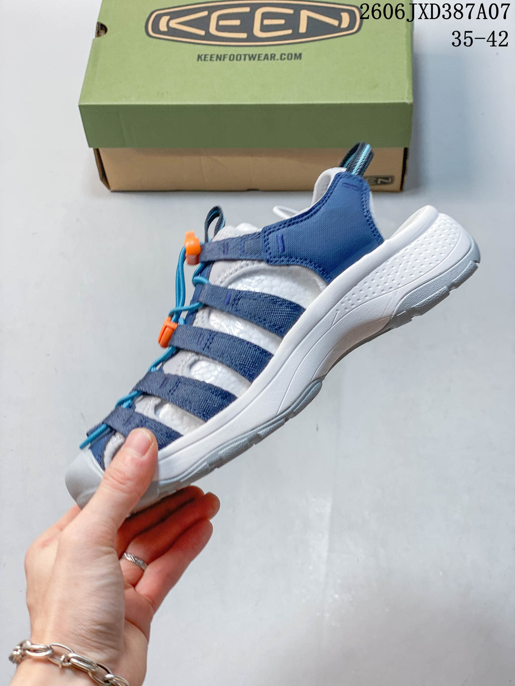 Side view of the blue and white closed-toe sandal