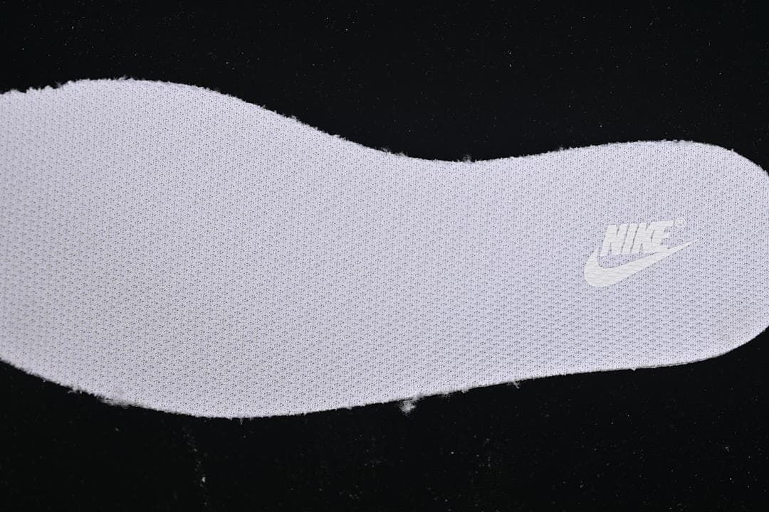 Close-up of a textured shoe insert with a Nike logo