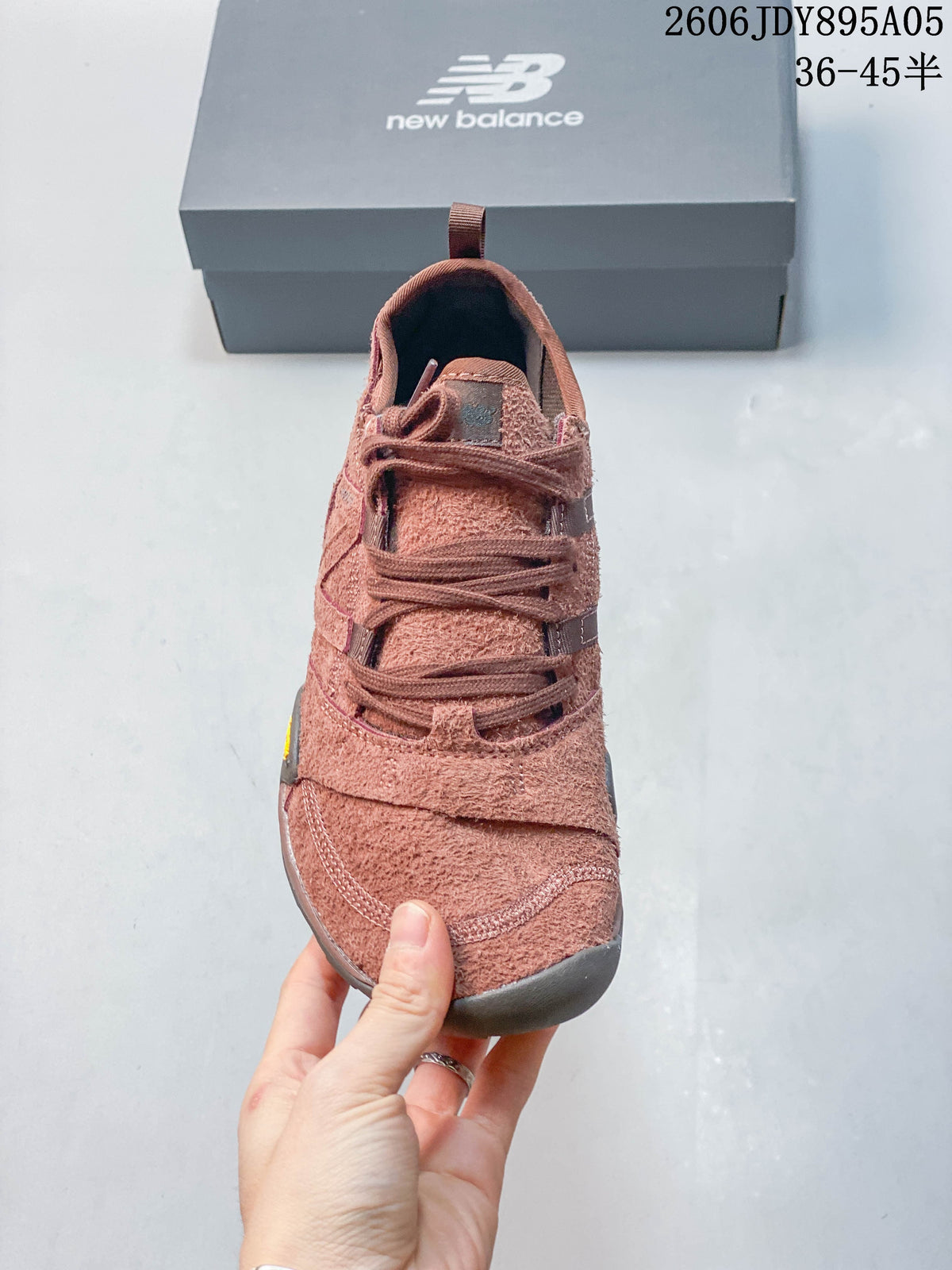 Front view showing the laces, tongue, and layered toe panels of the sneaker