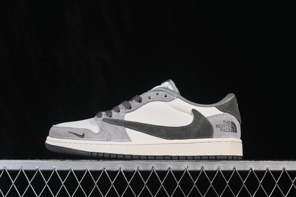 Side profile of a white and grey low-top sneaker with a dark oversized side logo and grey heel panel.