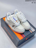 Pair of white Louis Vuitton-branded low-top sneakers with silver accents, shown on a shoebox.