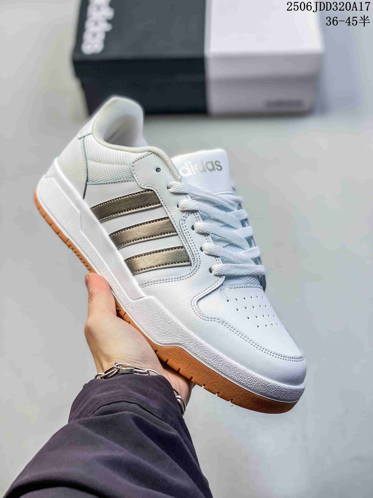 White adidas Entrap sneaker with muted metallic-tone stripes and a gum-colored outsole