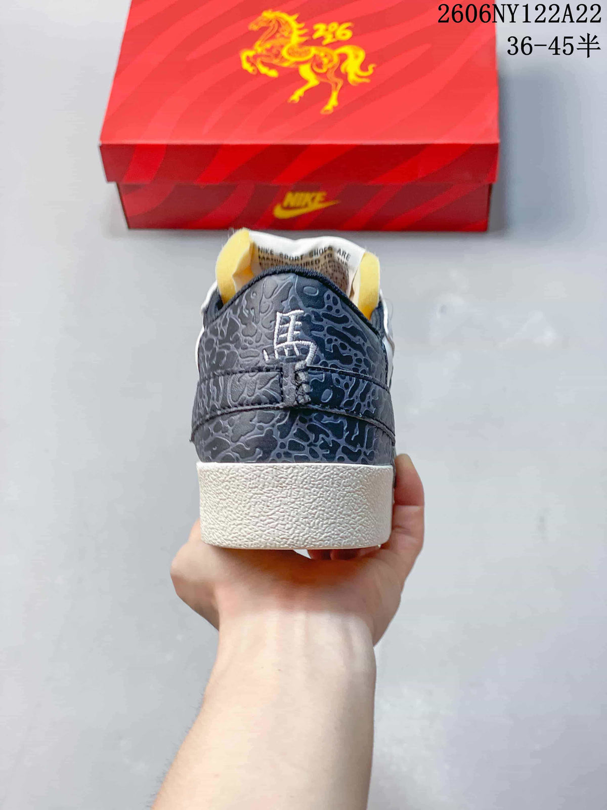 Rear view highlighting the dark gray patterned heel and off-white sole.