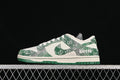 Side view of a cream and green Nike SB Dunk Low sneaker with patterned overlays and a green outsole