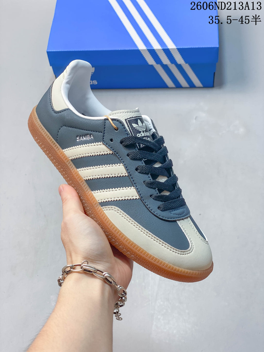 Angled side view of the blue and cream adidas Samba OG sneaker