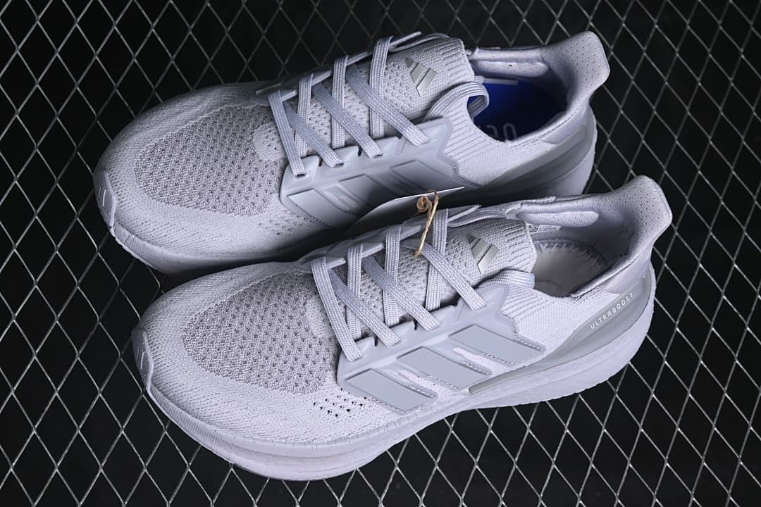 Pair of light grey Adidas Ultraboost 5 shoes viewed from above
