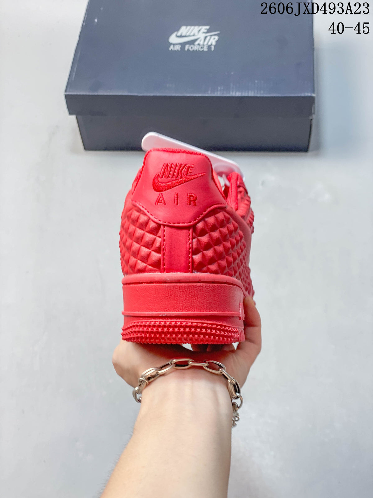 Rear view of a red low-top sneaker with textured heel panels