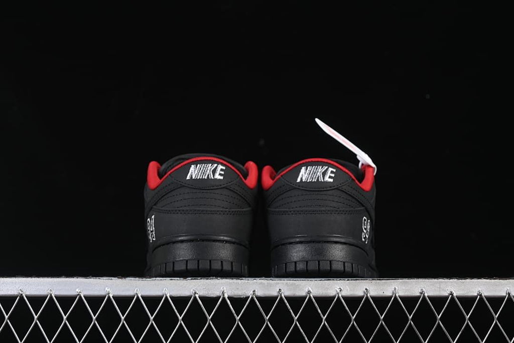Rear view of both shoes showing Nike heel embroidery and red lining