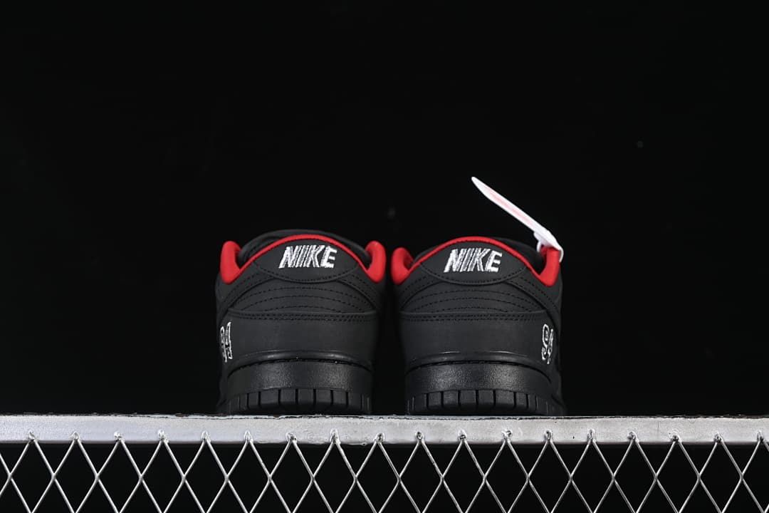 Rear view of both shoes showing Nike heel embroidery and red lining