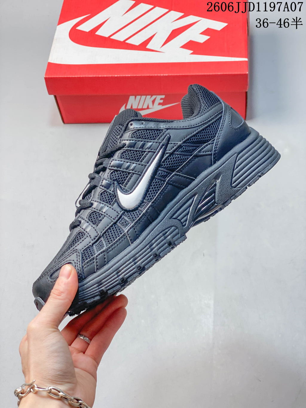 Side view showing layered panels and a light-colored Swoosh accent