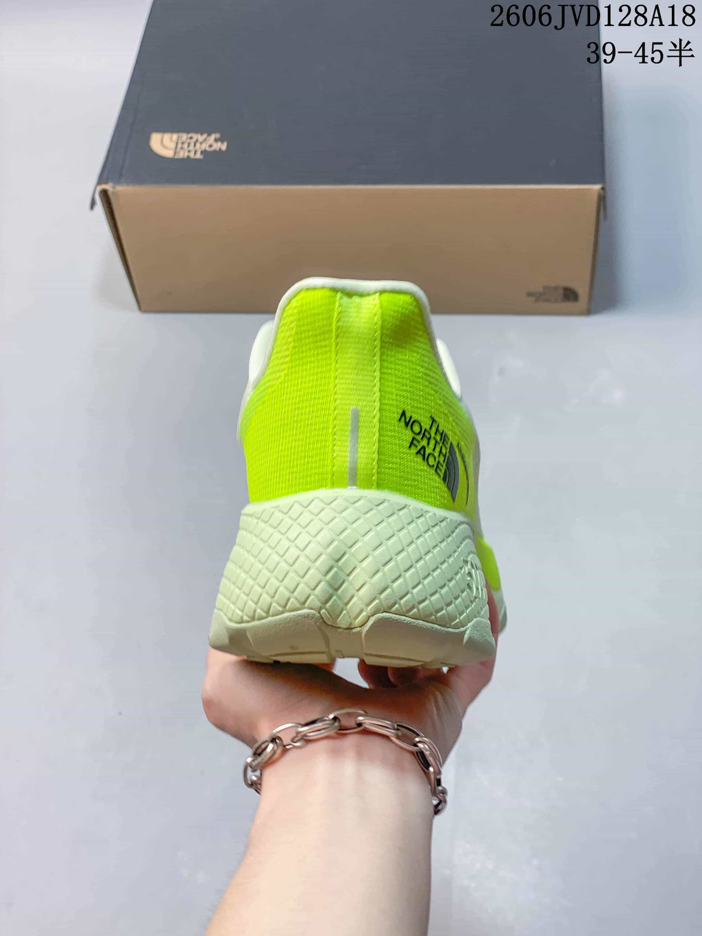 Rear view of the shoe showing its lime heel panel and sculpted sole