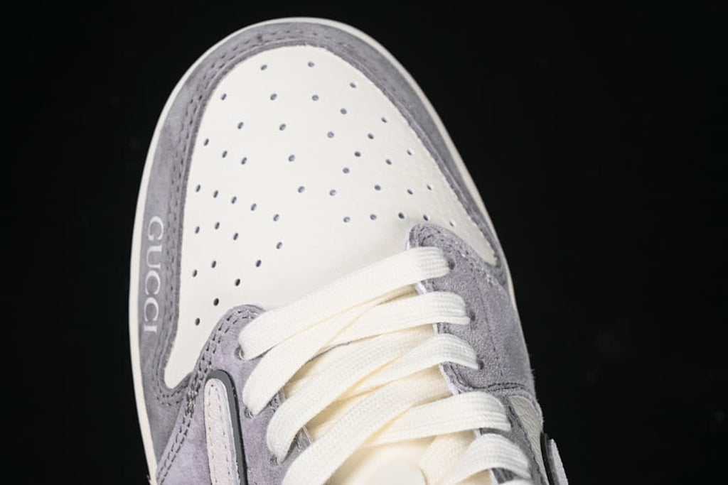 Top view of the perforated toe, gray trim, and cream-colored laces